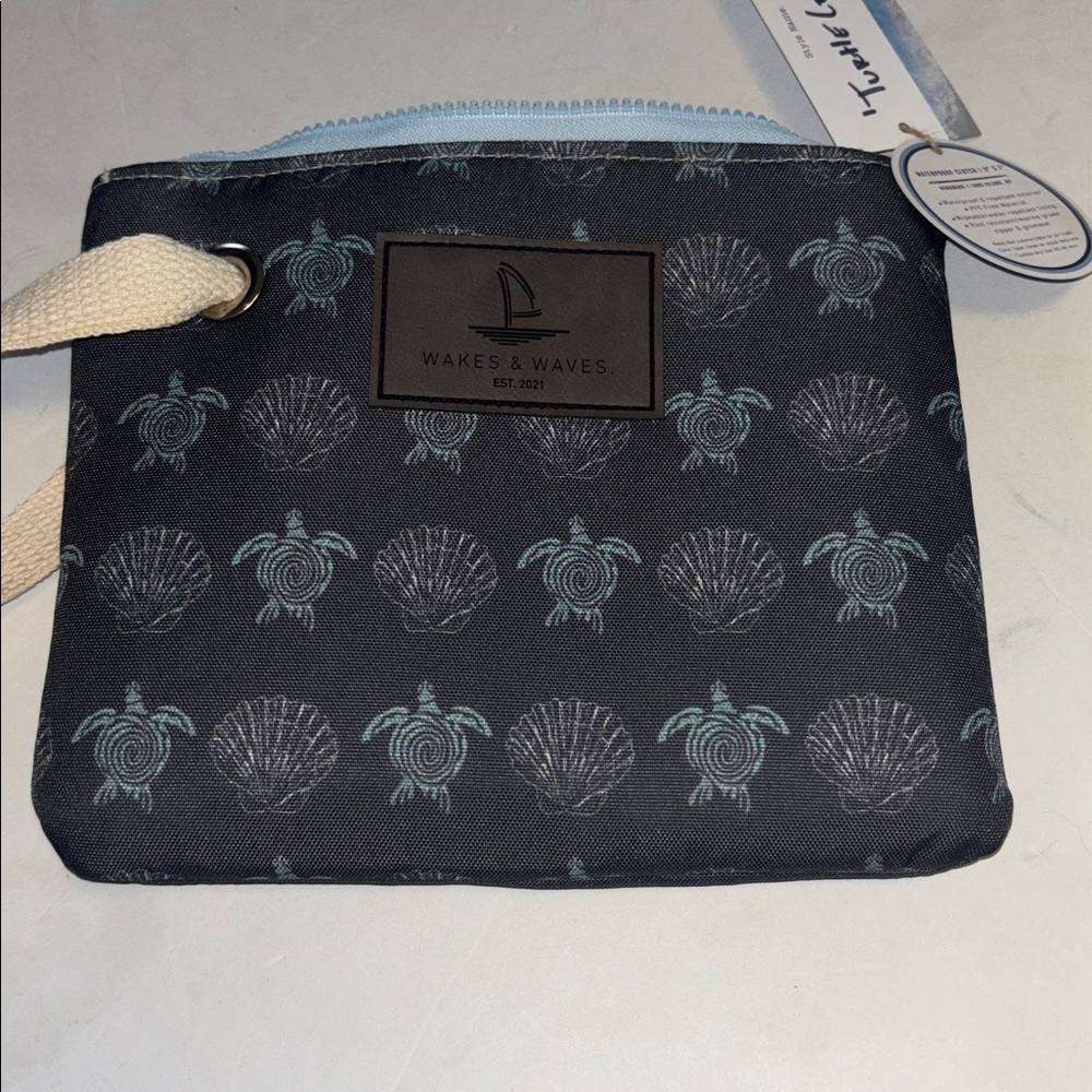 WAKES & WAVES BLUE WRISTLET WITH TURTLE DESIGN WATERPROOF CANVAS LIKE MATERIAL